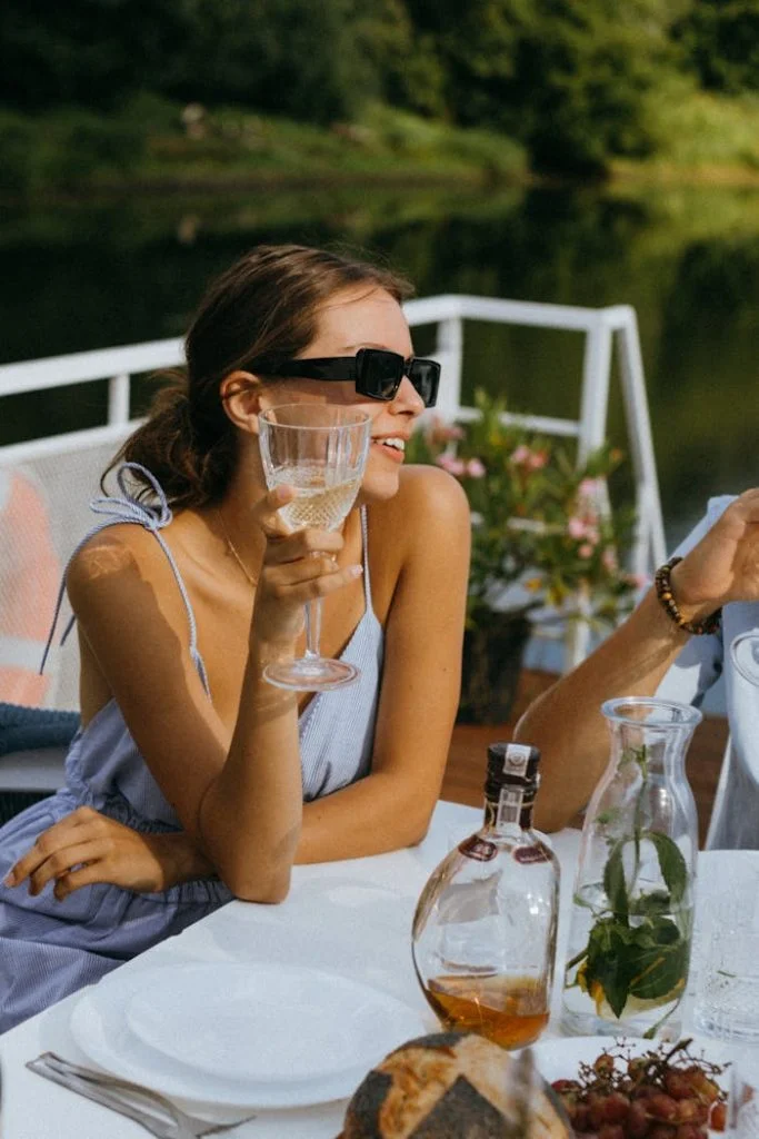 Woman relaxing with champagne on a yacht during a summer day.